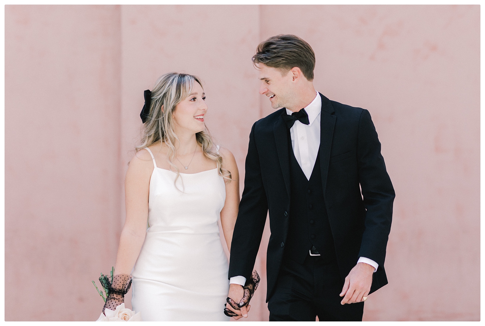 bride and groom savannah elopement against pink house