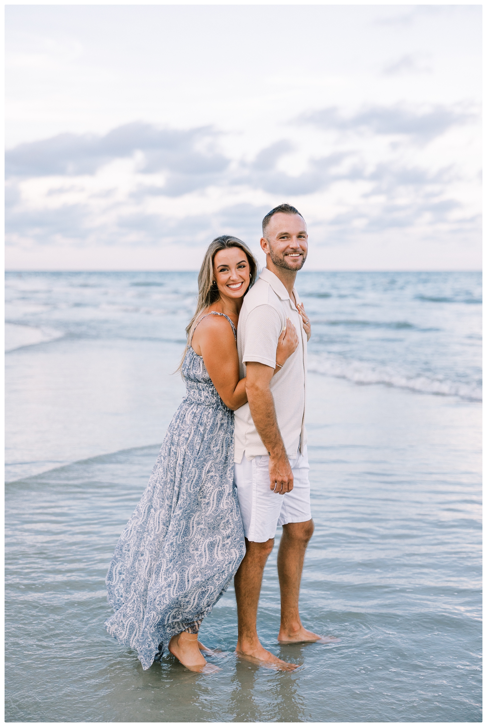 couple photo on the beach with the ocean in the background